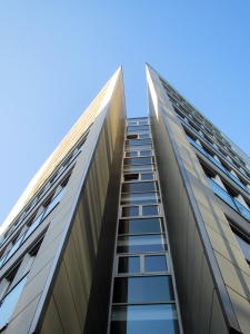 Image of contemporary office buildings against a clear sky, highlighting their modern design and commercial purpose.